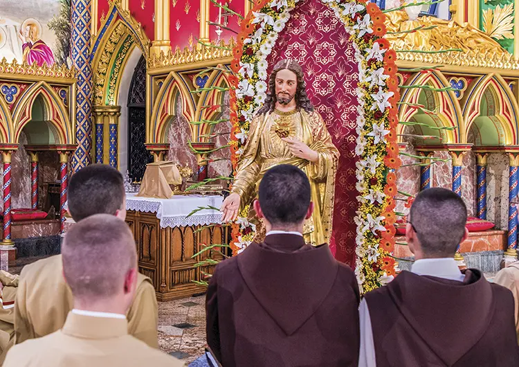 Heralds at the feet of a statue of the Sacred Heart of Jesus in the Basilica of Our Lady of the Rosary Caieiras Brazil