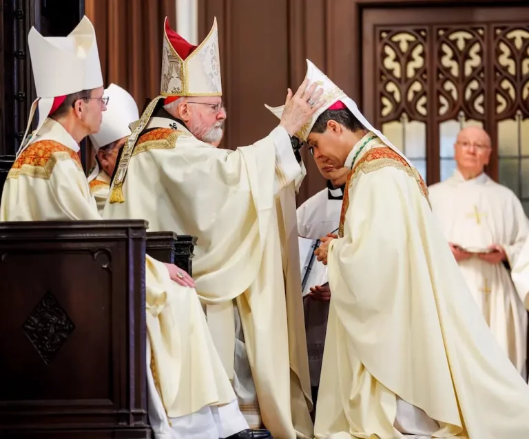 Cardinal Sean O'Malley laying hands on Bishop Cristiano